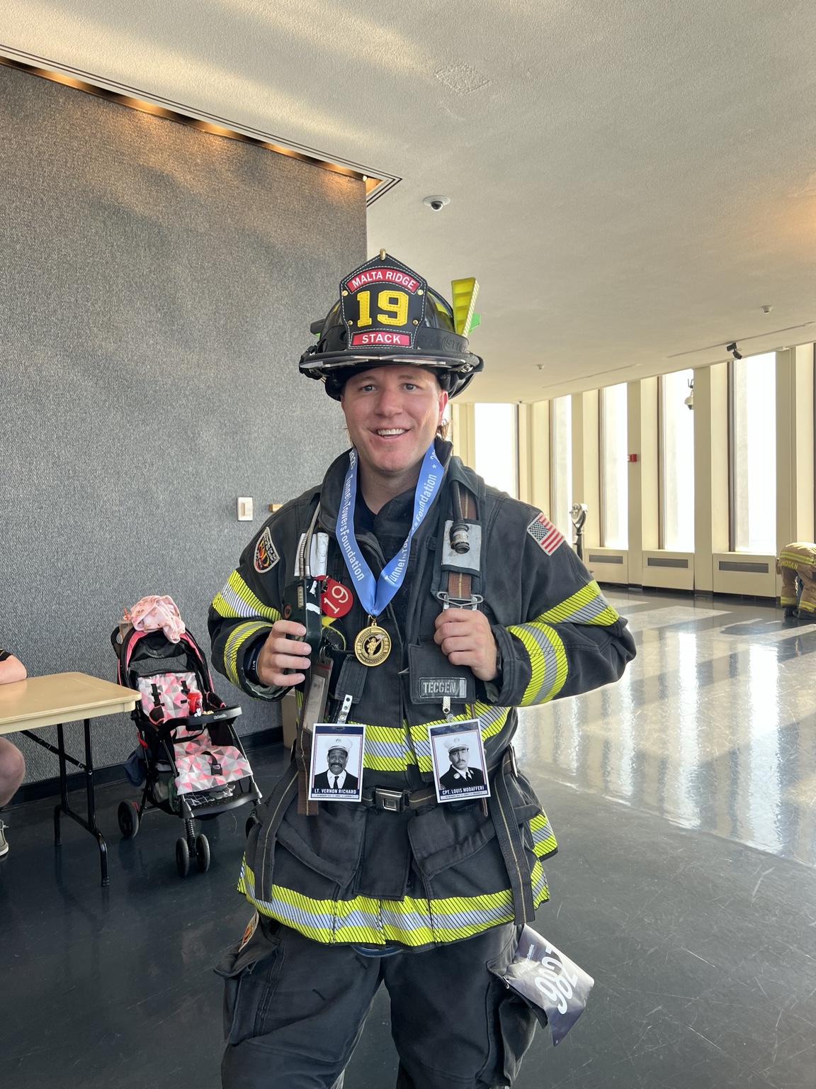 Jeff in Malta Ridge firefighter gear wearing a finisher’s medal